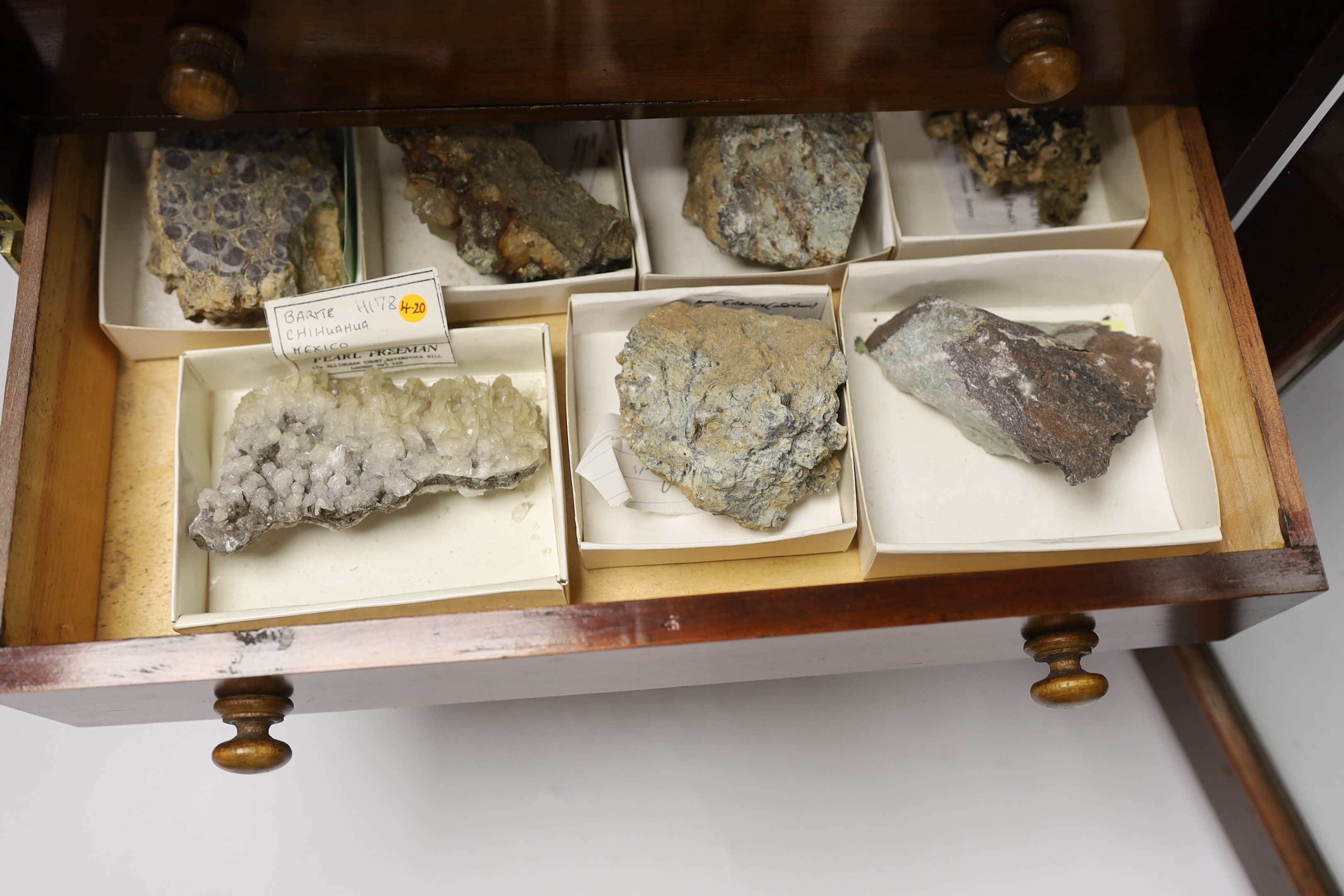 An early twentieth century six drawer pine collector’s cabinet of mineral and crystal samples including; Amber and insects in amber, Baryteson Calcite, Aplite, Nodular Rhyolite, Desert Roses, etc. many specimens with lab